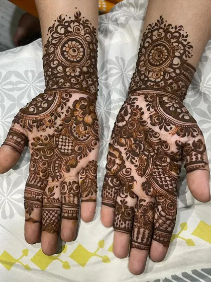 Another glimpse of my Eid henna work. This design features a prominent mandala cuff and dense patterns across both palms.