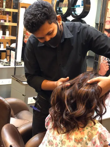 Our stylist adding the finishing touches to a client's new hair colour, ensuring every strand is perfectly placed.
