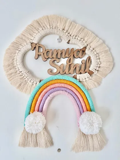 A lovely custom name hanging for Ramya and Sunil in soft pastel rainbow colors. The natural wood lettering adds a beautiful, rustic touch against the macrame cloud.