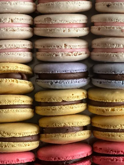 A colorful array of our handmade macarons. With crisp shells and chewy centers, these little bites of happiness are perfect for any occasion.