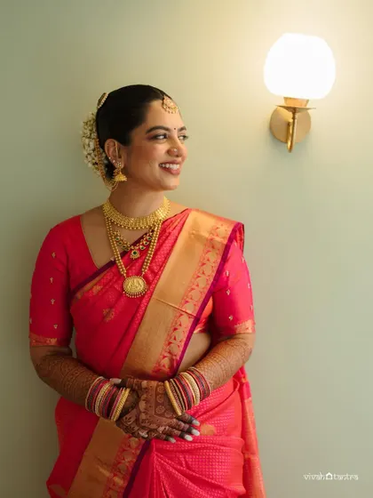 The bride's radiant smile is the most beautiful part of this look. The makeup is designed to enhance her natural beauty and celebrate her cultural roots.