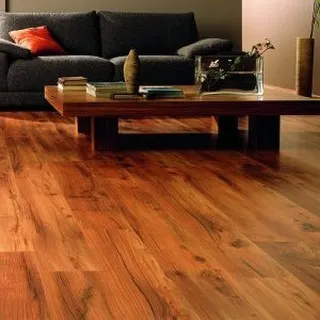The deep, reddish tones of this hardwood floor create a cozy and intimate atmosphere in this living room. It’s a classic choice that pairs well with dark furniture for a sophisticated, moody interior.