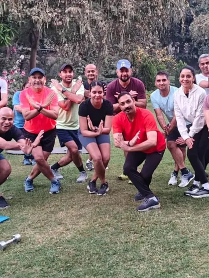 The tribe in a moment of focused fun during a strength session. We believe in training hard, but we also build a community that enjoys the process together.