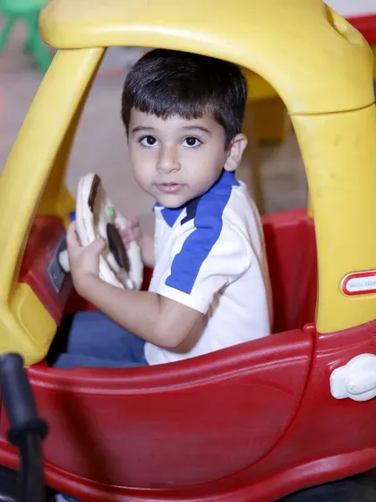 Another happy driver in our play area. The ride-on cars are perfect for toddlers and young children.