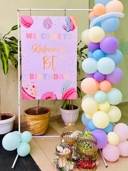 A sweet welcome sign for a 'Candyland' themed first birthday, decorated with pastel balloons.