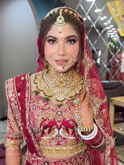 This bride wanted a "glass skin" look for her wedding day. I focused on creating a super dewy, reflective base with sharp, defined eyes and a neutral lip color to balance her ornate red lehenga.