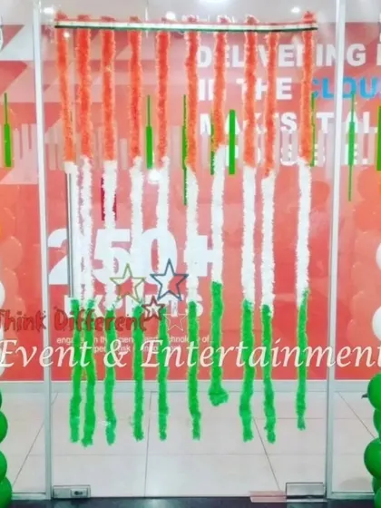 A welcoming entrance for an office, featuring tricolor balloon pillars and a curtain of flower garlands. This is a simple yet effective way to greet employees and visitors on a national holiday.