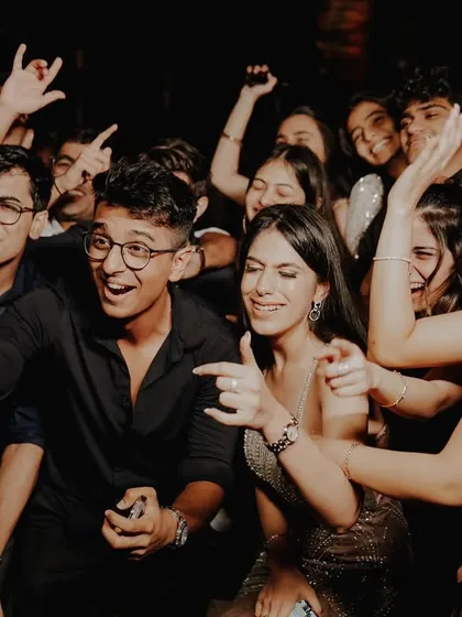 The party is in full swing. A candid shot of guests laughing and pointing, capturing the fun and interactive atmosphere.