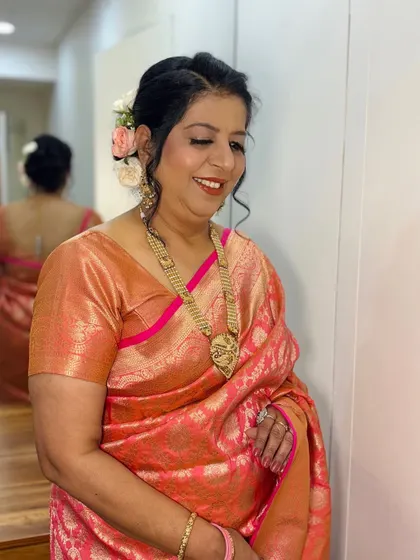 A smiling portrait, showing off her beautiful makeup and hair.