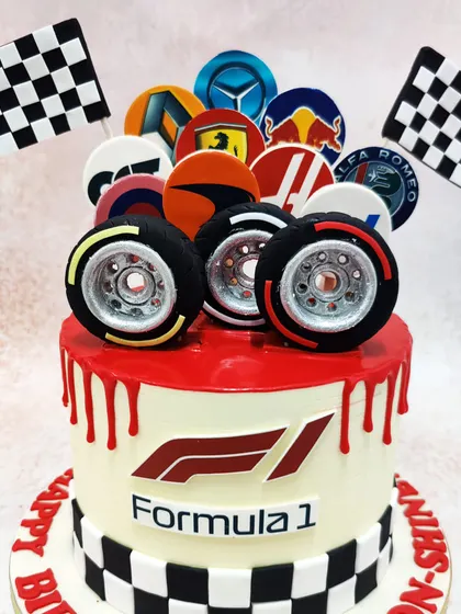 We bring the thrill of the race to your party with this high-octane Formula 1 cake. Featuring the F1 logo, checkered flags, edible tires, and the logos of top racing teams, this cake is a guaranteed winner for any motorsport enthusiast.