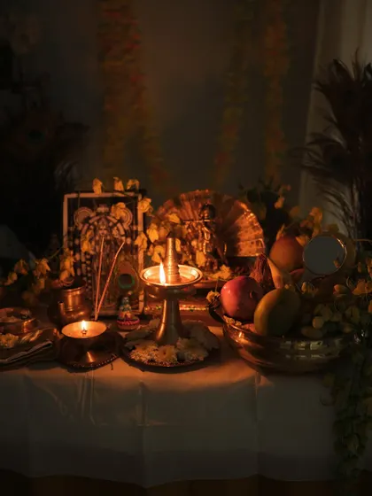 A wider view of the Vishu kani setup, showing the complete arrangement of auspicious items in a dimly lit, serene environment.