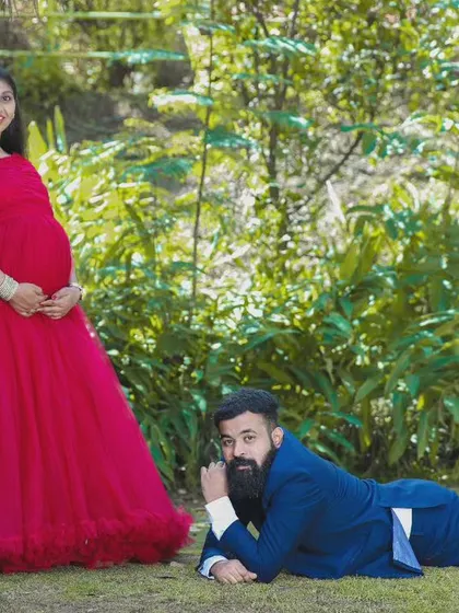 A fun and relaxed couple's portrait featuring the red flowy gown. This comfortable and elegant dress is perfect for capturing both posed and candid moments during your maternity photoshoot.