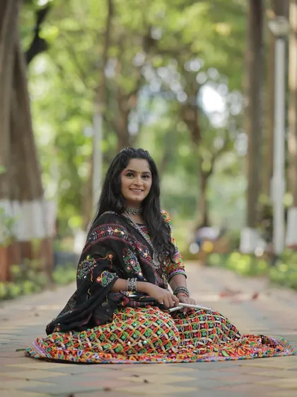 A beautiful portrait of my client ready for Navratri. Her traditional mirror-work ghagra choli is paired with silver jewelry and long, wavy hair.