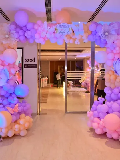 A grand entrance arch for the butterfly party. The mix of purple, peach, and pink balloons, along with delicate butterfly accents, sets a magical tone from the moment guests arrive.