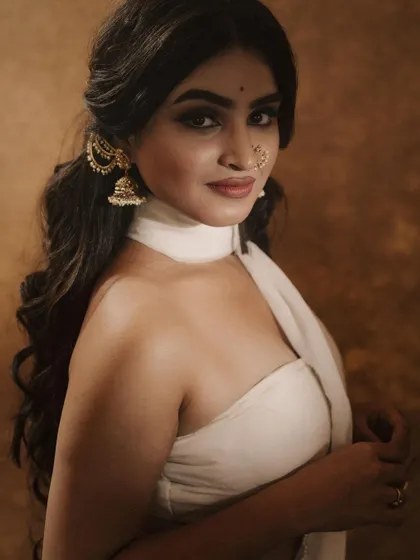 This look, created for a photoshoot, features a bold winged liner, a traditional nose ring, and soft waves, resulting in a modern yet classic aesthetic.