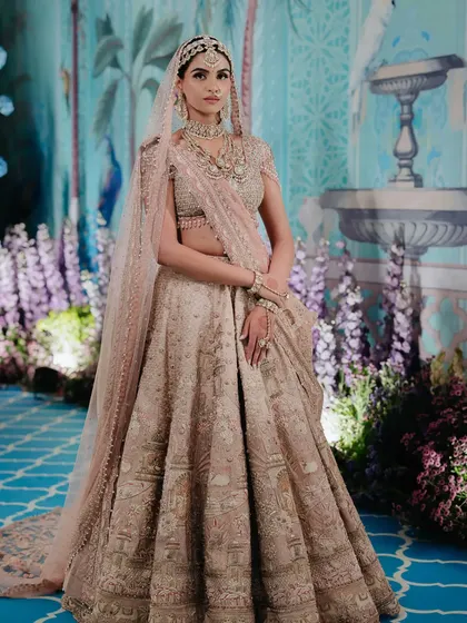 A full-length shot of a bride in a stunning pastel lehenga. This image, featured by WeddingSutra, highlights my work in creating modern, elegant bridal styles.