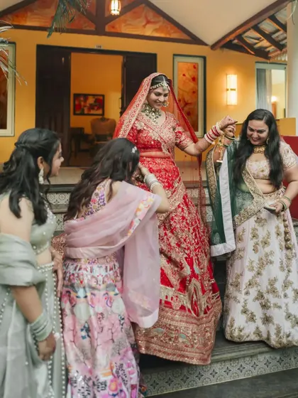 A fun and candid moment as the bride interacts with her bridesmaids during the Kalire ceremony.