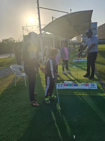 A young guest gets some pointers from a coach during a birthday party. My goal is to make golf accessible and fun for even the youngest players.