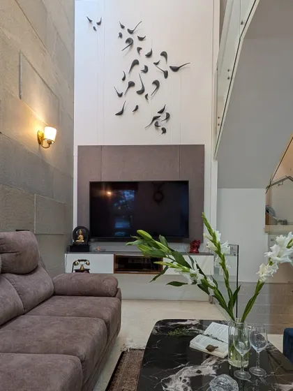 This angle highlights the verticality of the space, showing how the design elements work together in a double-height room.