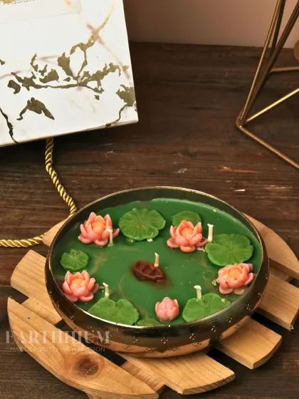 This Lotus Pond Urli candle captures the tranquility of a garden pond. I sculpted tiny lotus flowers, lily pads, and even a small boat to float in the green wax, making it a truly unique decor piece.