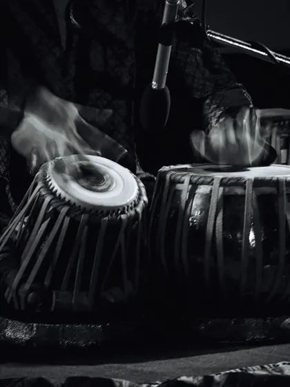 An artistic shot of the tabla in motion. The blur captures the speed and energy of the hands, representing the 'blast from the past' and the timeless power of rhythm.