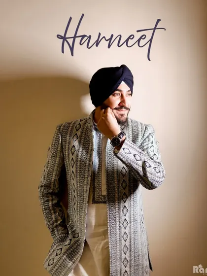 A handsome portrait of the groom in his stylish engagement attire. The simple background and warm lighting put all the focus on his personality and anticipation for the big day.