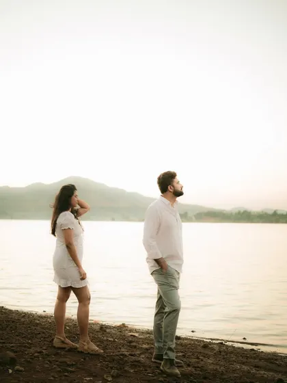A contemplative moment by the lake at dusk, creating a moody and atmospheric pre-wedding portrait.
