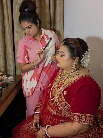 Here I am, in my element, putting the final touches on Shreyoshi's bridal look for her anniversary celebration. Every brush stroke is done with care and precision.