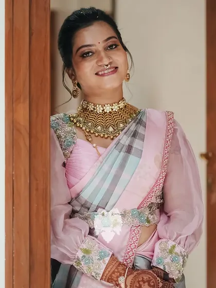 Kavya Maruthi's contemporary light pink silk blouse with sheer puffy sleeves and 3D embroidery for her housewarming.