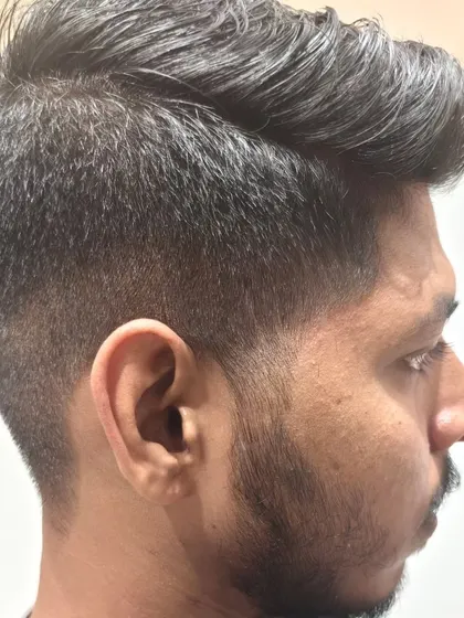A final "after" shot from the side, showing the clean fade and styled hair.