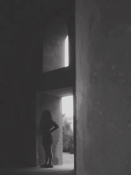 A silhouette in a stark, architectural space. This minimalist and moody shot captures the feeling of solitude and introspection that fuels my creativity.