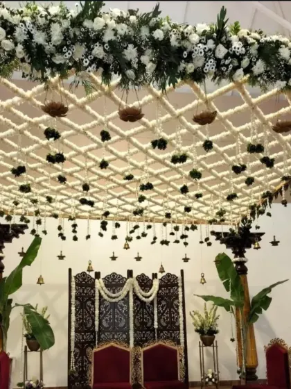 A breathtaking view of a traditional mandap ceiling we designed. The intricate lattice is woven from thousands of jasmine buds, with hanging floral elements and brass bells that create a divine atmosphere for the ceremony.