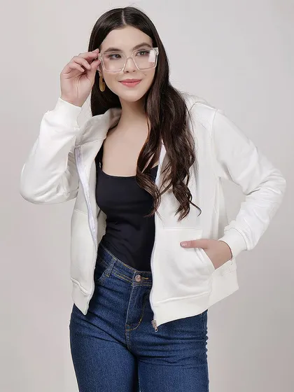 A clean studio shot of a model in a white zip-up hoodie and jeans, perfect for showcasing basic apparel essentials.