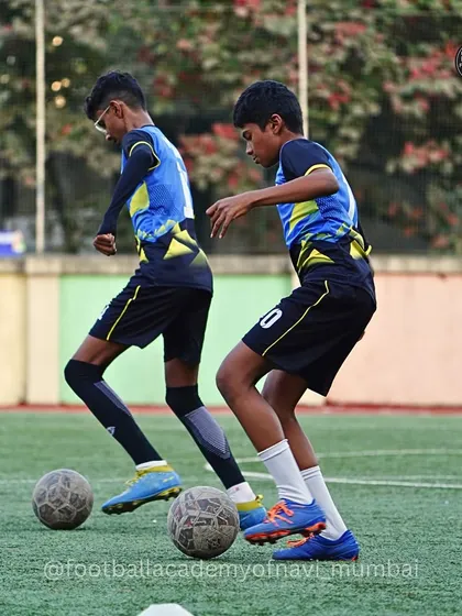Two players work on a coordinated dribbling drill. These exercises are designed to improve teamwork and passing in motion.