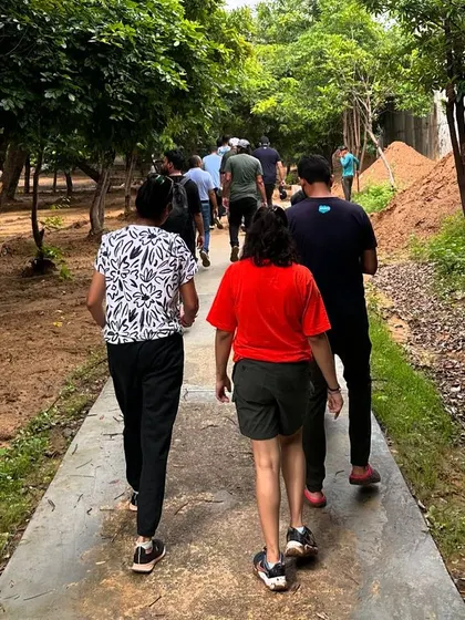 Volunteers from Salesforce walk along the restored path at Aravali Creek, experiencing the green space they are helping to create.