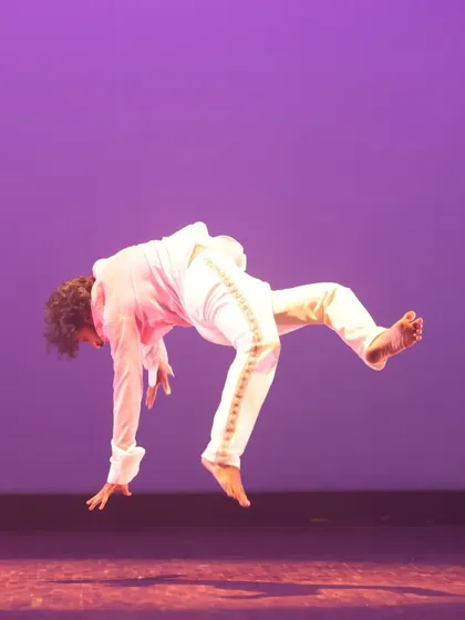 A faculty member executes a dynamic leap during a contemporary performance at SparkLights 2024. This action shot captures the power, athleticism, and technical skill we bring to our contemporary choreography and training.