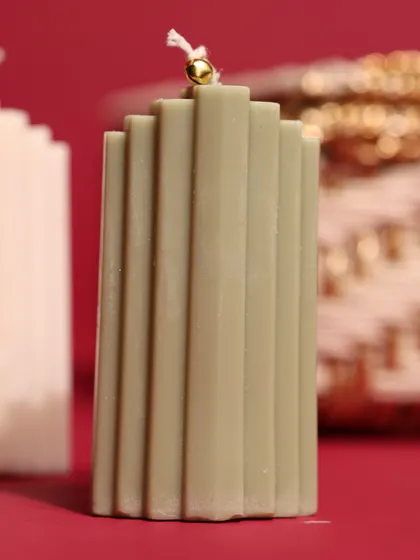 A modern, sage-green ribbed pillar candle, perfect for adding a touch of contemporary elegance to a Christmas or corporate hamper.