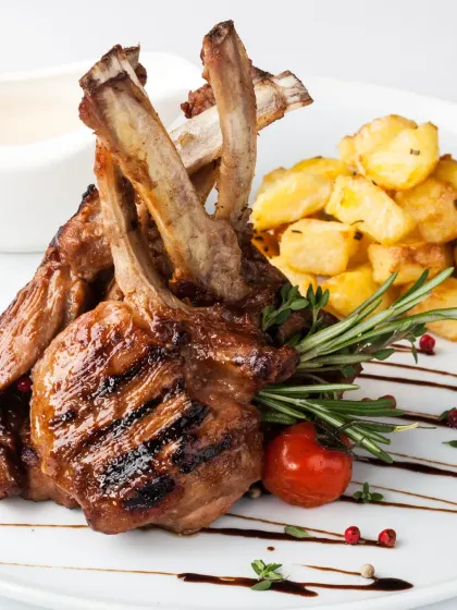 Perfectly grilled lamb chops served with rosemary-infused confit potatoes and roasted vine tomatoes. The char on the meat provides a beautiful contrast to its tender, succulent flavour.