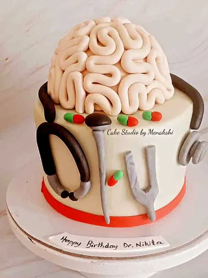 A cake for a neurosurgeon. This unique design features an edible brain, a stethoscope, and other medical tools.