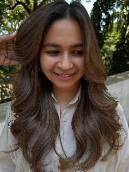 A happy client with her refreshed beige hair.