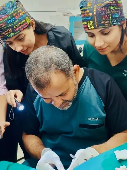 Learning from a master is an invaluable experience. Here, I am observing a procedure closely during my dermatosurgery fellowship. This hands-on training ensures I can offer the latest and most effective surgical techniques to my patients.