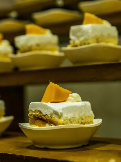 Mini mango mousse cakes, perfectly portioned and arranged for easy serving. A light and tropical dessert option that is always a crowd-pleaser.