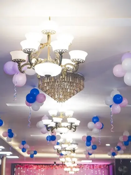 A shot of the ceiling decorations, showing how lighting and simple balloon arrangements can transform a venue.