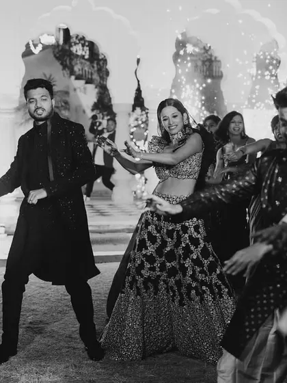 The party doesn't stop on stage. This shot captures the couple and their friends enjoying a dance on the floor, showing the infectious energy of the celebration.