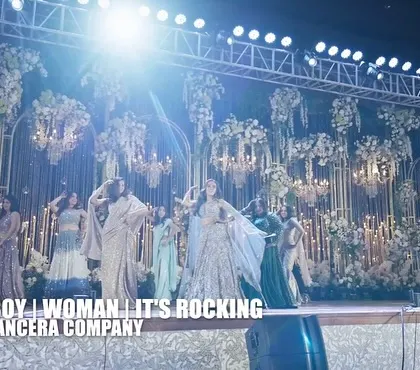 The full bride tribe owning the stage. The grand floral backdrop and dramatic lighting made their performance look absolutely spectacular.