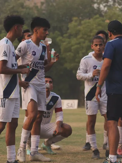 A quick hydration break and tactical discussion during a training session. Even our breaks are focused on strategy and improvement.