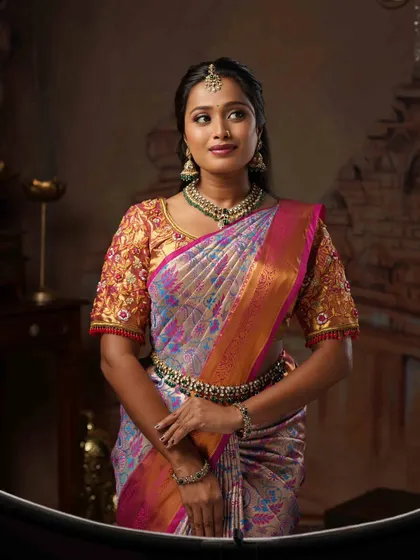 A closer view of the makeup and jewellery for this look. The soft, natural makeup allows the intricate details of the saree and necklace to stand out.