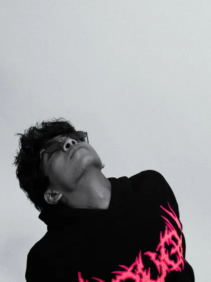 A dramatic black and white shot of an artist, showcasing the creative potential of simple lighting and a clean background.