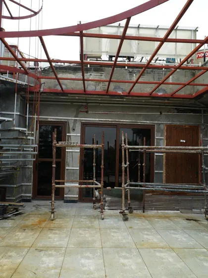 Another angle of the Pitampura terrace project in progress. You can see the scaffolding and the raw structure of the spiral staircase and pergola, hinting at the major overhaul to come.