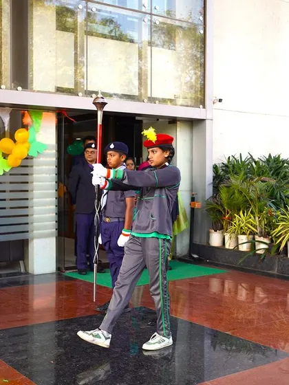 The student guard of honor marches with precision, carrying the ceremonial torch to begin the Republic Day festivities.